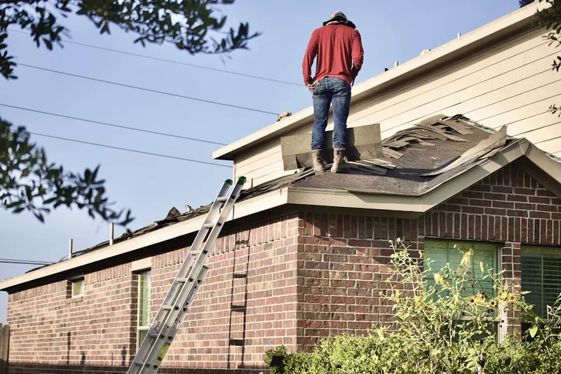 Professional roofer working on a residential roof in Tully Lake Park